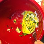 Whisking egg, parsley and cheese