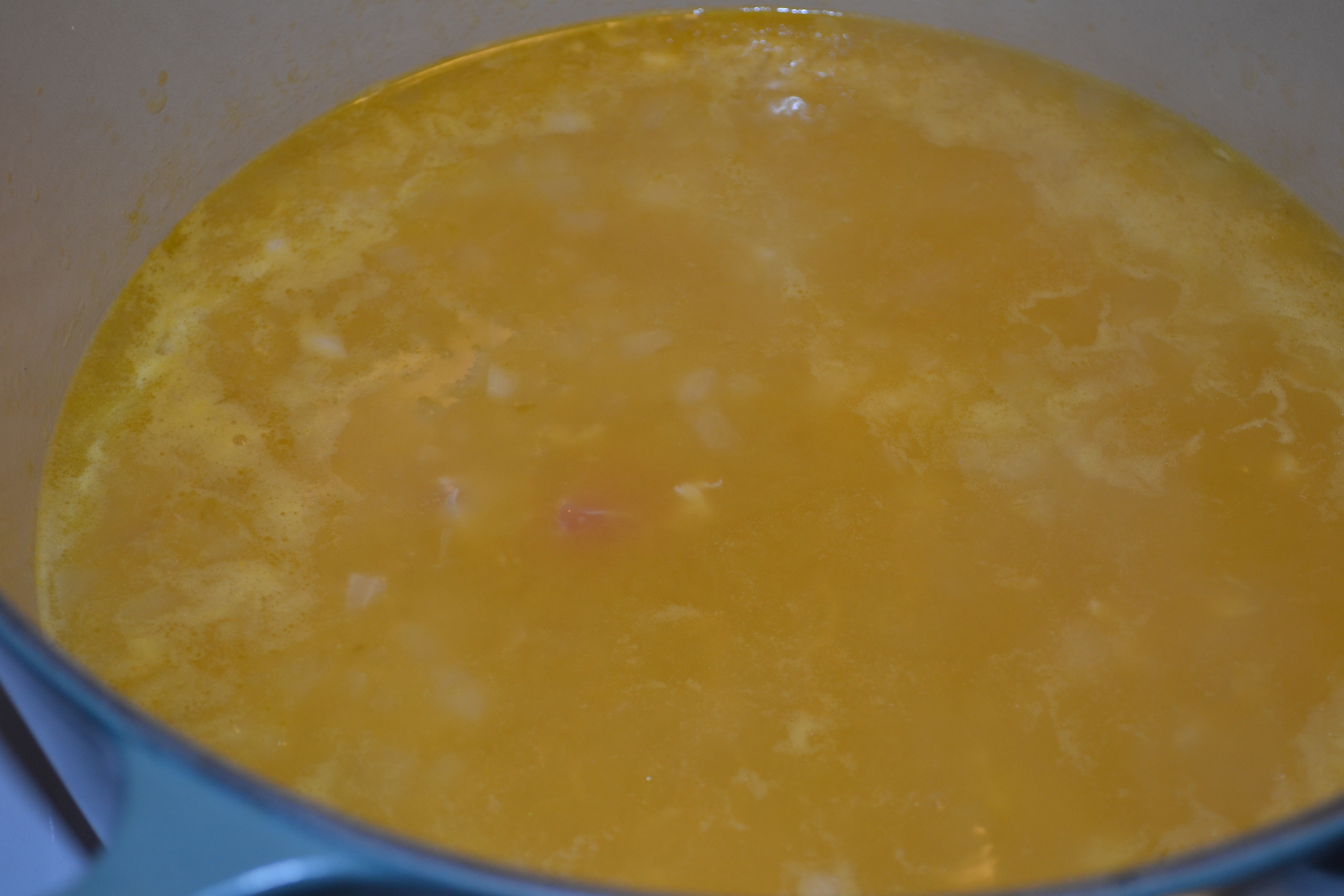 Boil chicken stock with onions and garlic